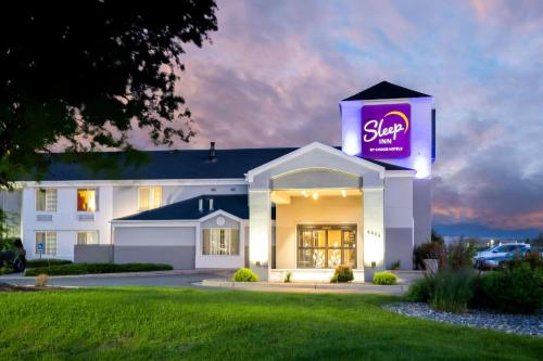 a large white building with a sign on it at Sleep Inn Billings in Billings