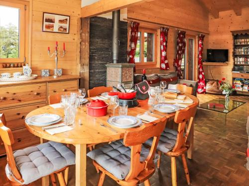 a dining room with a wooden table and chairs at Chalet La Bergerie by Interhome in Nendaz