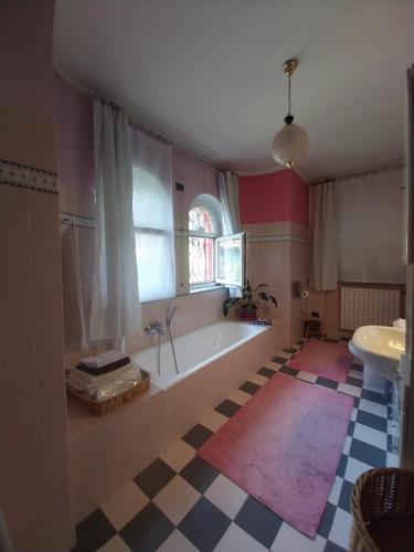 a bathroom with a tub and a window and a sink at A casa di Lara in Beura