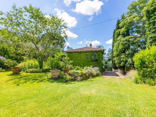 a green house with a yard with plants at Villa Villa Vittoria by Interhome in Pian di Scò