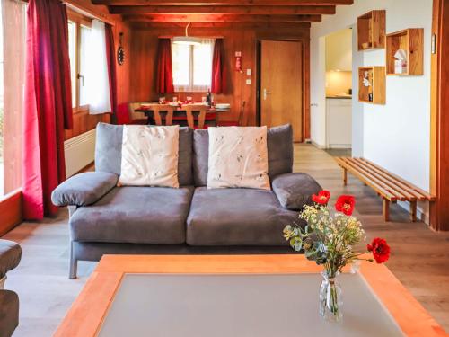 un salon avec un canapé et une table dans l'établissement Chalet Dorine by Interhome, à Nendaz