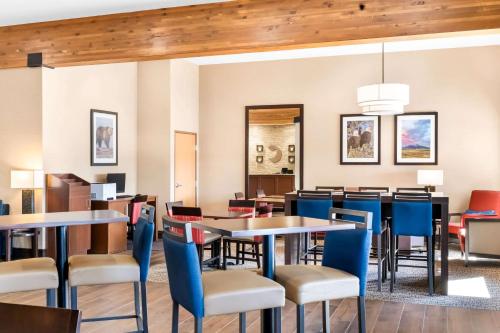 a dining room with tables and chairs at Comfort Inn at Buffalo Bill Village Resort in Cody