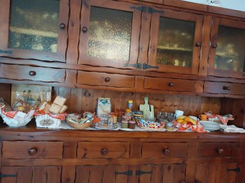 a wooden cabinet with food on top of it at A casa di Lara in Beura