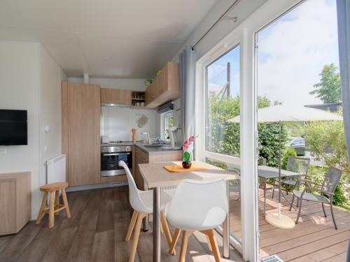 a kitchen and dining room with a table and chairs at Holiday Home Tiny Haus Altmühlblick Nr- 83 by Interhome in Beilngries