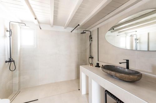 a bathroom with a sink and a mirror at Rania Apartments Sea View in Mýkonos City