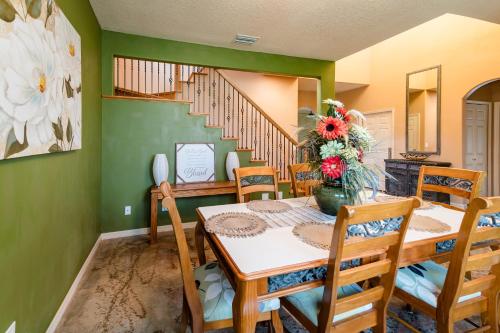 a dining room with a table and chairs and a staircase at Chic Renovated Oasis- Disney & Universal Nearby home in Palm Bay