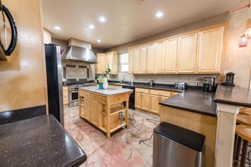 a large kitchen with wooden cabinets and a island at Chic Renovated Oasis- Disney & Universal Nearby home in Palm Bay
