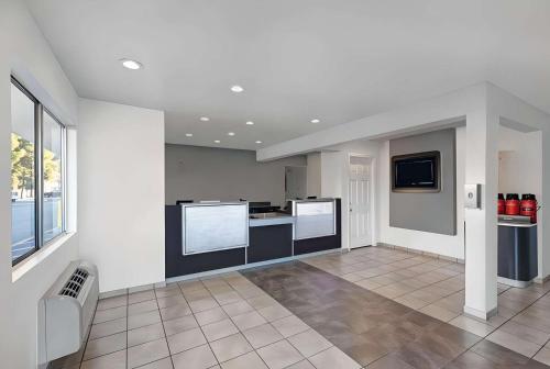 a large kitchen with white walls and a tile floor at Park Inn by Radisson, San Jose in San Jose