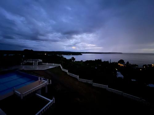 a view of a body of water at dusk at Pango Ocean Blue Hotel in Port Vila
