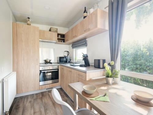 a kitchen with wooden cabinets and a table and a window at Holiday Home Tiny Haus Engel by Interhome in Beilngries