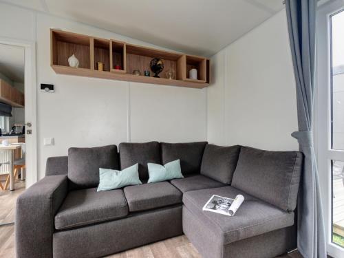 a living room with a couch and a table at Holiday Home Tiny Haus Sonnendeck by Interhome in Beilngries