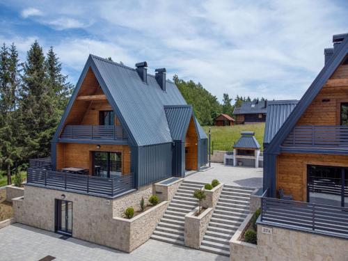 a house with a metal roof and stairs at Holiday Home Vuk by Interhome in Kupjak
