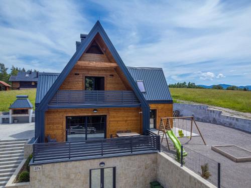 a house with a gambrel roof at Holiday Home Vuk by Interhome in Kupjak