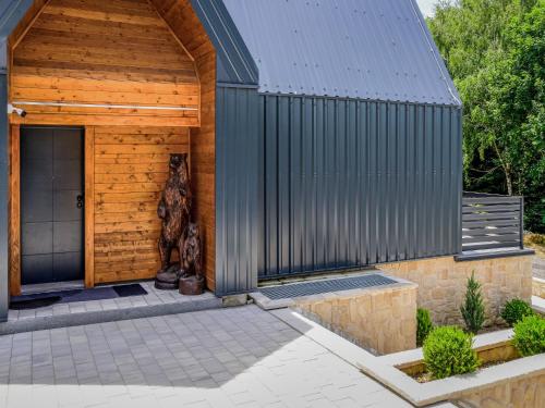 a building with a dog sitting outside of it at Holiday Home Vuk by Interhome in Kupjak
