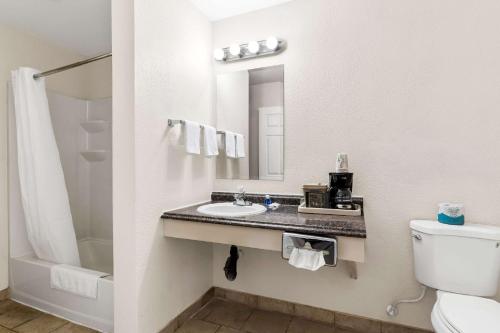 a bathroom with a sink and a toilet at Rodeway Inn Hermiston - Umatilla in Hermiston