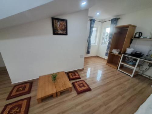 a living room with a table and a couch at MrLee Dalat House in Da Lat