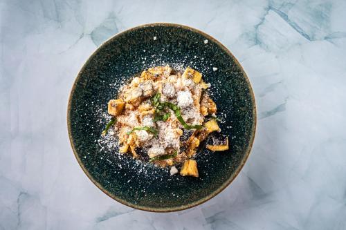 a bowl filled with food on a table at Heliotrope Hotels in Mytilini