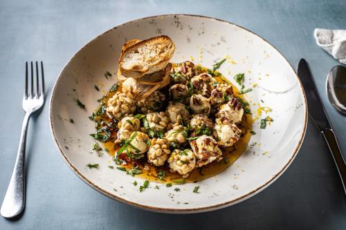 a plate of food with bread and shrimp and toast at Heliotrope Hotels in Mytilini