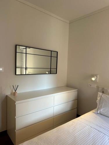 a bedroom with a dresser and a mirror on the wall at Blue Cozy Nest in Rhodes Town