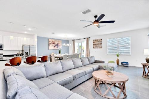 a living room with a couch and a table at Upstay Luxury Resort Home w Private Pool & Hot Tub in Kissimmee