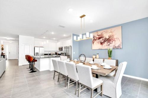 a dining room and kitchen with a table and chairs at Upstay Luxury Resort Home w Private Pool & Hot Tub in Kissimmee