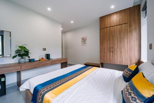 a bedroom with a large bed and a wooden cabinet at Lotus Premium Lodge - Lotus Group Tours in Ha Giang