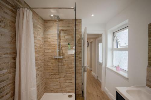 a bathroom with a shower and a sink at montrose lodge in Cheltenham
