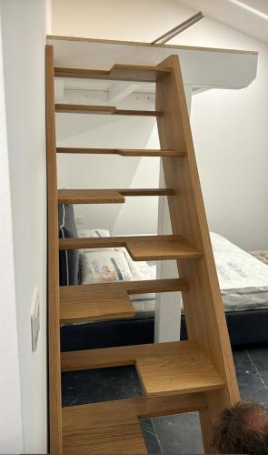 a wooden staircase leading to a bunk bed at Suite Aurora in Crotone
