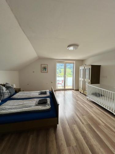 a large bedroom with a bed and a wooden floor at Ferienwohnung in Kaning in Kaning