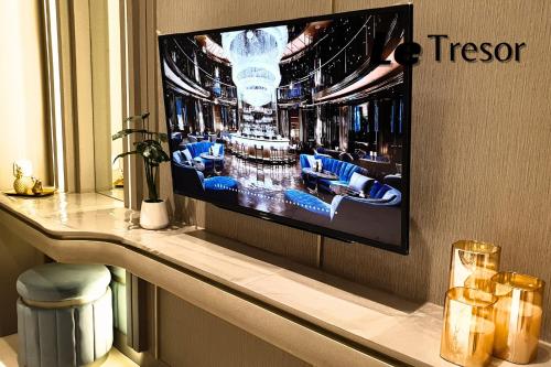 a television hanging on a wall in a room at Le Tresor Benson Apartment at Supermal Pakuwon in Surabaya