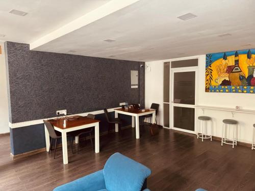 a room with two tables and chairs and a painting at CityRest Fort in Colombo