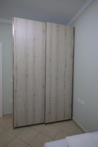 a room with two wooden doors on a wall at Holiday Apartment in Vlorë