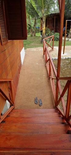 a pair of shoes sitting on a wooden walkway at Gombela Ecolodge and Farming in São Tomé