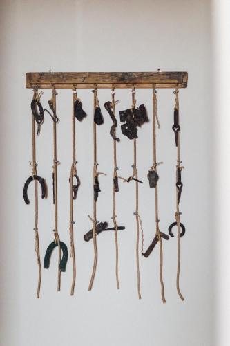 a group of wooden weapons hanging on a wall at Podere Biricocolo - Il Cortile in Bucine