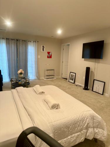 a bedroom with a large bed and a flat screen tv at Home Away in Hanover