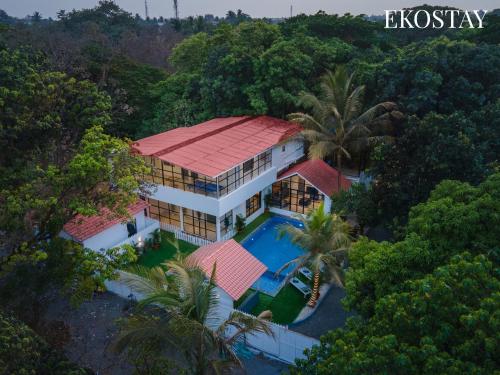 an aerial view of a house with a swimming pool at EKOSTAY - White Oak Villa in Alibaug