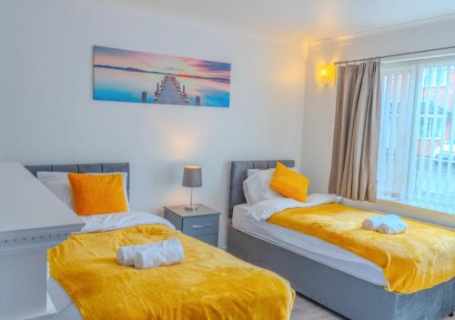 a bedroom with two beds and a window at Property Malak Homes - Coalville in Coalville