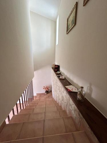 a hallway with a staircase with a tile floor at Agriturismo Francemili in Cerreto Sannita
