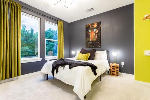 a bedroom with a bed and a large window at Two-House Private 10BR Compound - DT 6 Min Drive in Austin