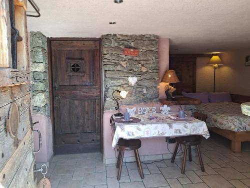 a room with a table and a bed and a bedroom at CleMaison Antica Dimora Apartments CIR VDA GIGNOD 0013 in Gignod