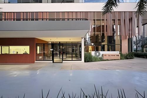 an external view of a building with glass doors at Vida Urbana - Allegro - Setor Oeste in Goiânia