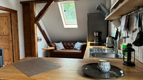 a kitchen with a table with a cup of coffee on a counter at Ferienwohnung - Der Schwarzstorch in Fehrbellin