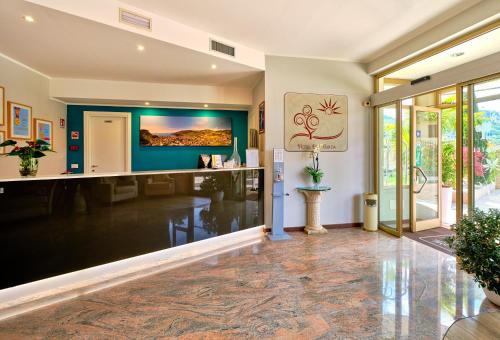 a home office with a large screen tv on the wall at Hotel Eden Garda in Garda