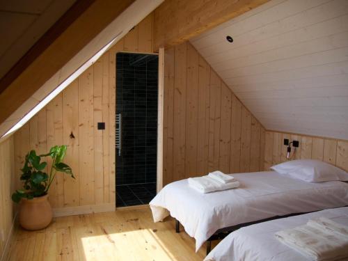 a attic bedroom with two beds and a window at Villa Bord de Mer, Vue Océan et Accés Plage in Soulac-sur-Mer
