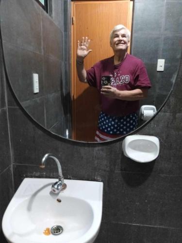 a man standing in front of a bathroom mirror at The Soul Center in Batuan