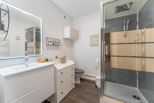 une salle de bain avec un lavabo et un miroir dans l'établissement Cosy Gallieni - Bel appt avec terrasse à Merignac, à Mérignac