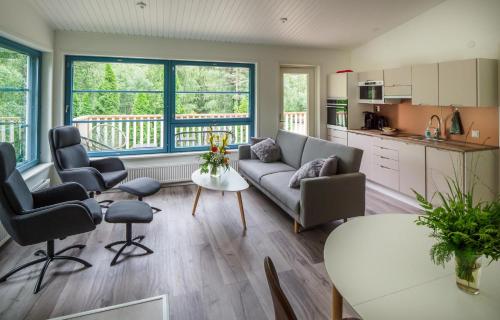 a living room with a couch and a table at Polku Hotelli in Vihti