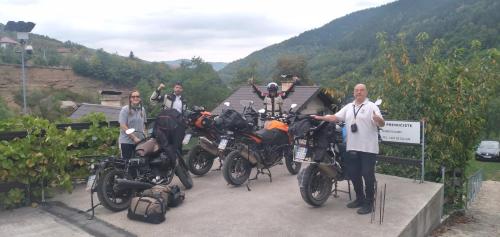 a group of three men standing next to motorcycles at Prenoćište na Drini Foča in Foča