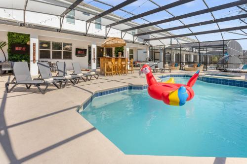 a pool with a inflatable shark in the water at Upstay Family Resort Mansion- Pool, Games, Theater in Kissimmee