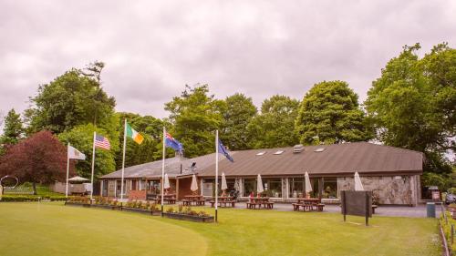 a building with flags in front of it at Waterford Castle Hotel Lodges in Waterford